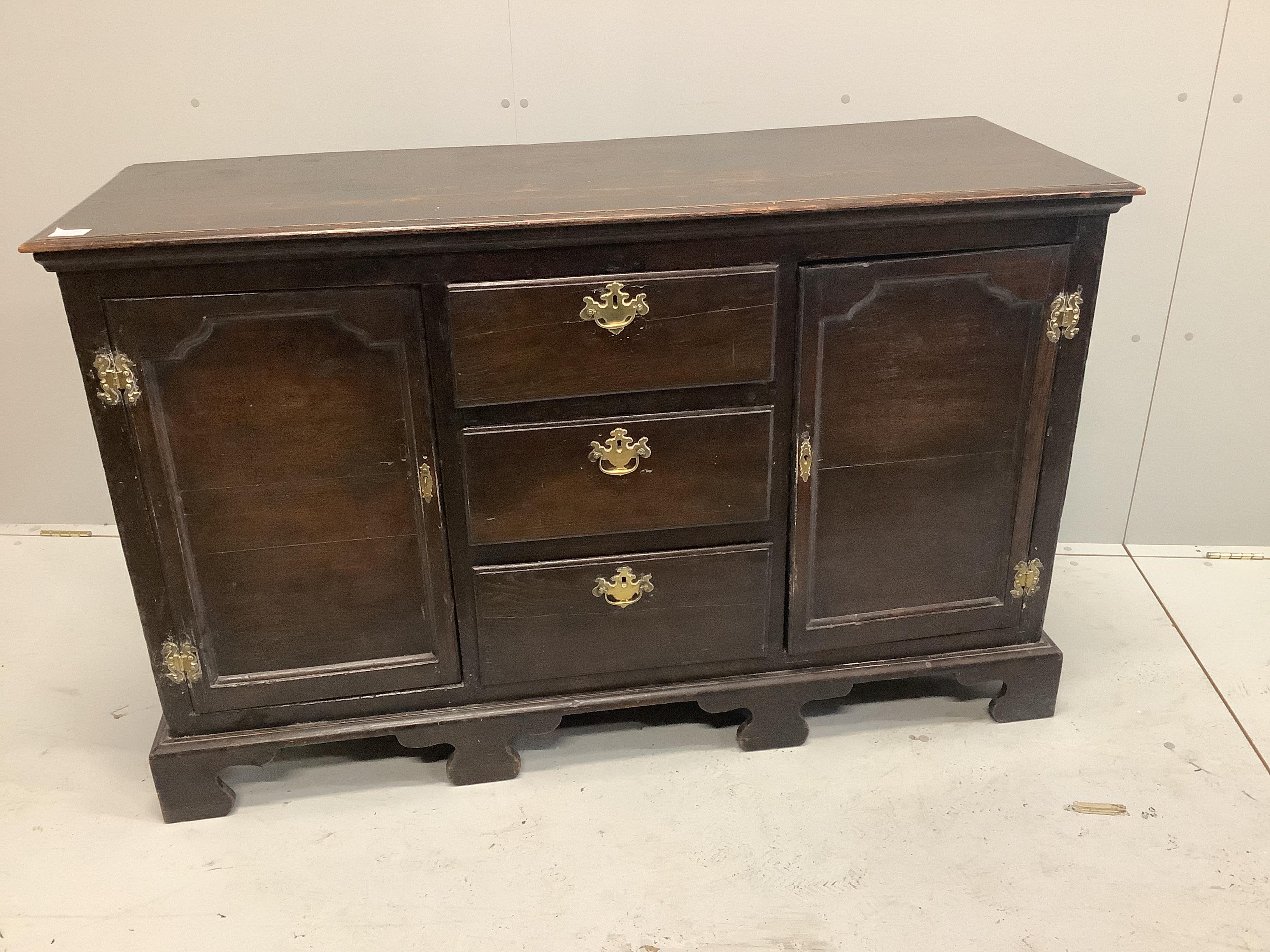 An 18th century sideboard of small proportions raised on bracket supports, width 140cm, depth 50cm, height 87cm